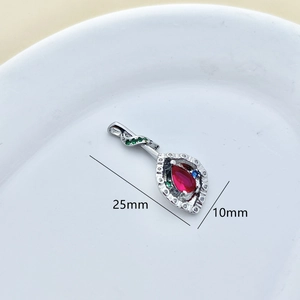 Detailed macro view showing the 25mm silver floral pendant with red teardrop stone