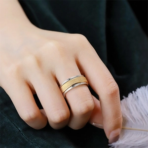 Close-up of rotating frosted titanium steel ring for meditation on finger