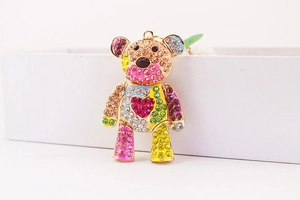 Close-up of colorful rhinestone bear keychain with gold finish and pink heart detail