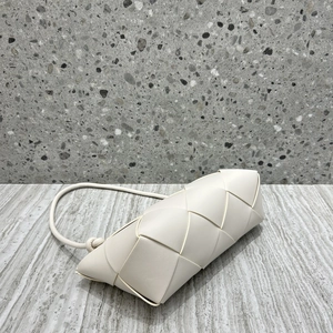 Detail of white woven genuine leather texture and knot design on luxury crossbody bag