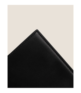 Macro shot of precise stitching and premium black leather texture on the crossbody bag