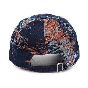 Detail of adjustable metal buckle and vintage jacquard pattern on denim baseball cap