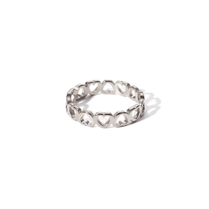 Macro detail of silver stainless steel ring with continuous hollow heart pattern design