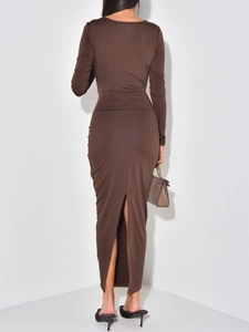 Detail view of the elegant brown long-sleeve maxi dress back with a sleek rear slit design