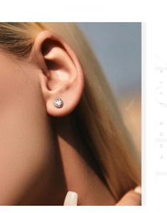 Close-up of s925 silver oval stud earring with sparkling cubic zirconia on a model