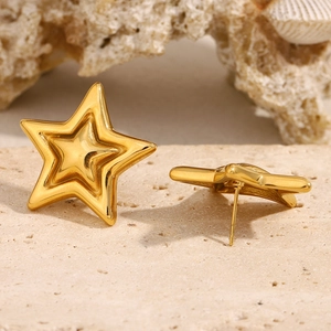 18K gold plated stainless steel star stud earrings on a textured stone and coral background