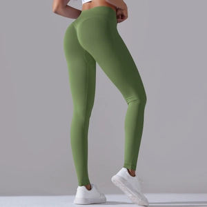 Detailed back view of green seamless yoga leggings with cross waist and peach butt lift