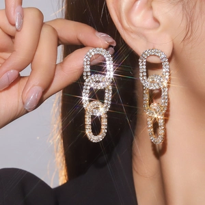 Macro detail of luxury geometric chain earrings with silver gold plating and rhinestones