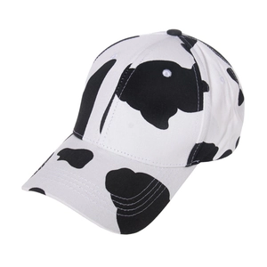 Close-up of fabric texture and black and white cow print pattern on baseball cap