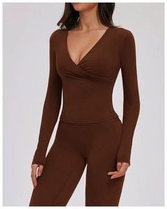Detail of chocolate brown long sleeve V-neck wrap yoga top and high waist leggings set