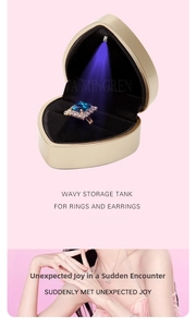 Macro detail of heart-shaped LED jewelry box with champagne gold finish and black velvet lining
