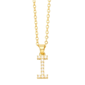 Macro shot of gold necklace featuring letter I pendant with elegant pearl inlay