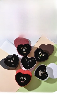 Macro shot of heart-shaped jewelry boxes with soft flocking lining and textured paper
