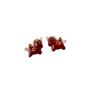 Minimalist red enamel horse stud earrings with gold plating on a white background