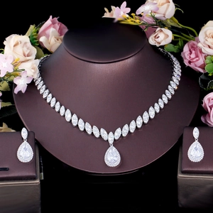 Detail of bridal jewelry set with marquise and pear-cut zircon necklace and earrings