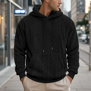Close-up of black teddy fleece hoodie with 3D jacquard texture and street style details