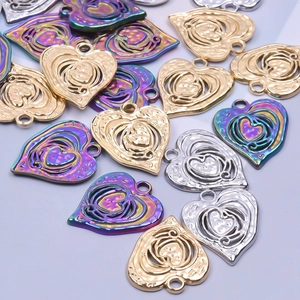Macro view of hollow heart pendants in gold, silver and rainbow colors for jewelry DIY