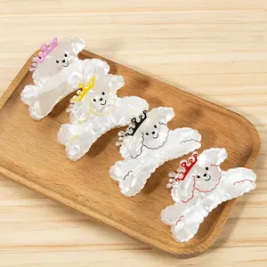 Set of four cute cartoon poodle hair claws in pink, yellow, black, and red colors