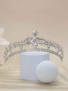 Detailed view of silver bridal crown with crystals on studio display props