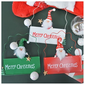 Detail view of festive gnome metal signs with Merry Christmas text for tree hanging