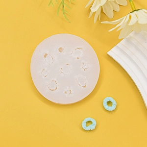 Silicone mold for multi-cavity mini donuts and chocolate cakes on yellow background