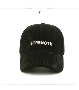 Detailed close-up of 'STRENGTH' embroidery on a premium black corduroy baseball cap