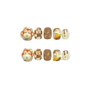 Handmade press-on nails featuring cute 3D cartoon monkey and banana theme designs