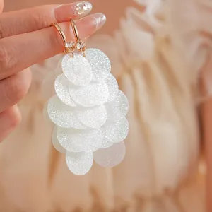 Exaggerated C-shaped silver needle tassel earrings with shimmering white sequins and rhinestones