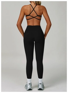 Detail view of high waist yoga leggings with V-shaped seam and criss-cross sports bra