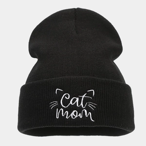 Close-up of Cat Mom embroidery on a black ribbed knit beanie for autumn winter fashion