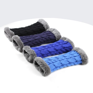 Detail of cable knit fingerless gloves with grey faux fur trim in various blue tones