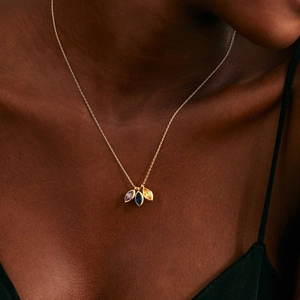 Gold necklace featuring three teardrop zircon stones in purple, blue and yellow hues