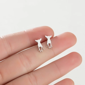 Detailed close-up of chihuahua dog silhouette stud earrings in polished silver steel