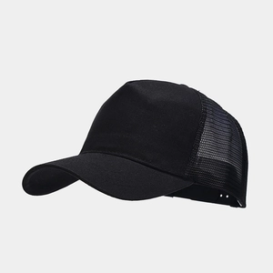 Close-up of black trucker hat with breathable mesh back and solid fabric panel