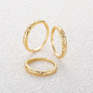 Detailed view of S925 sterling silver stamp and sparkling star zirconias on gold ring