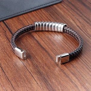 Close-up of brown braided leather bracelet with silver spring-ring and magnetic clasp