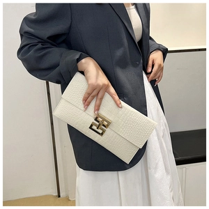 Détail de la pochette en feutre blanc à motif crocodile et boucle dorée géométrique