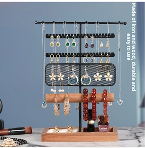 Detailed view of jewelry organizer with iron frame and wooden base for necklaces