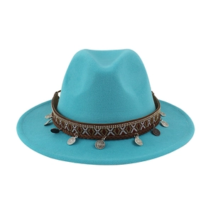 Detail of teal wool felt fedora featuring ethnic woven band and silver coin pendants