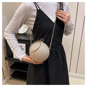 Detail of champagne gold spherical evening clutch with sparkling finish and ring handle