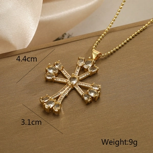 Detailed view of an 18K gold plated cross pendant with clear cubic zirconia stones