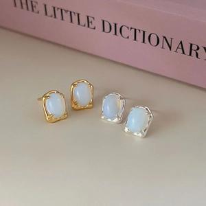 Irregular 925 sterling silver stud earrings with oval moonstone in gold and silver finish