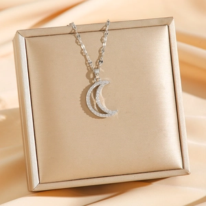 Pave moon pendant necklace in silver plating on elegant jewelry box display