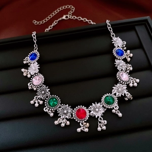 Detailed macro view of vintage flower pendant necklace with colorful gemstones and bells