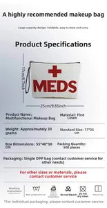 Detail showing the 17x25cm red letter MEDS print on white linen toiletry bag