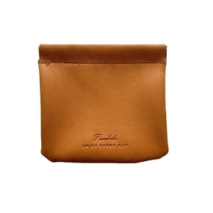 Brown leather travel cosmetic bag with squeeze top closure and minimalist design