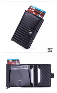 Detail view of carbon fiber texture wallet showing internal slots and metal snap closure