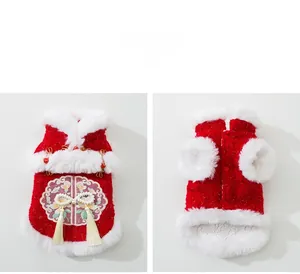 Detailed view of red festive dog vest with traditional embroidery and pearl tassels