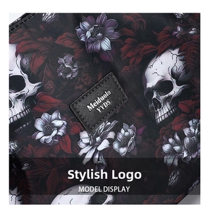 Macro shot of gothic Oxford fabric with skull and floral patterns and a woven logo label