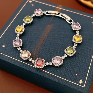 Vintage style bracelet with multi-color zircons and silver clasp on blue leather
